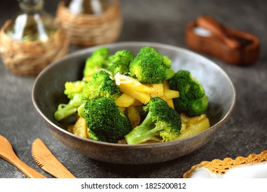 Boiled broccoli with fried potatoes.