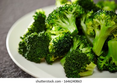 Boiled broccoli on white plate 