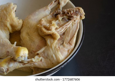 Boiled Chicken Leg Quarters. Serving Of Cooked Chicken Legs In A White Metal Bowl. Close-up. Selective Focus.