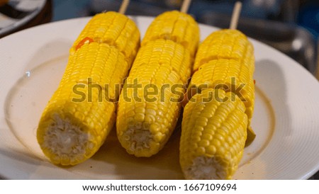 Boiled corn with cow butter and salt. Vegetarian food market