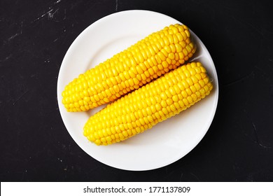 Boiled Corn On A White Plate, Top View