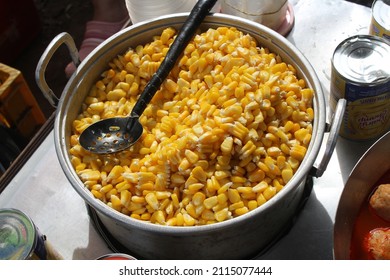 boiled corn in a pot of delicious and cheap street food - Shutterstock ID 2115077444