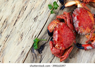 Boiled crabs on wooden surface with copyspace. top view