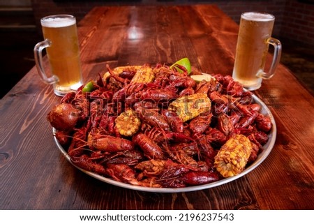 Boiled Crawfish with corn on the cob, potatoes and lime.
