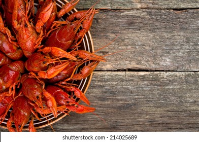 boiled crawfish on wooden surface