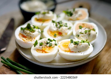 Boiled egg halves with mayonnaise and green onions.