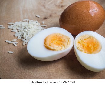 Boiled Egg On Wooden Background And Fresh Egg With Rice.