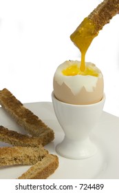 Boiled Egg With Toast Fingers Yolk Dripping From Toast