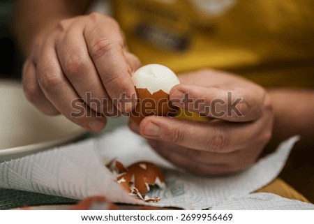 Boiled eggs for breakfast. Man remove eggshells, boiled egg. Eating proteins.