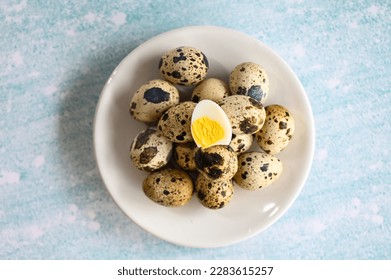 boiled eggs food, quail eggs on white plate, breakfast eggs with fresh quail eggs on table background