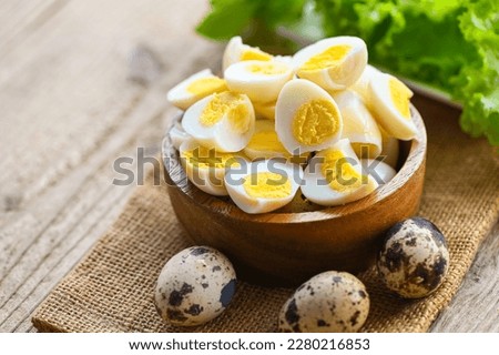 boiled eggs food, quail eggs on wooden bowl, breakfast eggs with fresh quail eggs and vegetable lettuce on table background