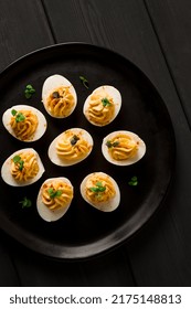 Boiled Eggs Stuffed With Yolk With Mayonnaise, On A Black Plate, Selective Focus, Blurry, Close-up, No People,