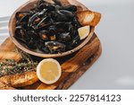 boiled mussels with parsley, spinach, Asian herbs and lemon and toasted baguette