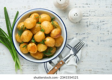 Boiled new or young potatoes with butter, fresh dill and onions in white bowl on white old rustic wooden background. Tasty new boiled potatoes. Top view. - Powered by Shutterstock