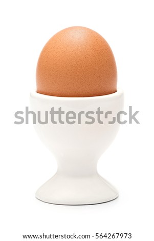 Boiled organic chicken egg in ceramic cup or holder isolated on white