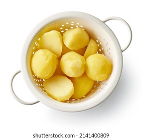 boiled potatoes in strainer isolated on white background, top view