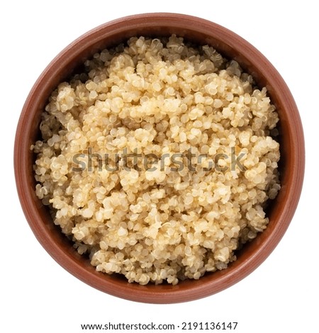 Boiled quinoa in bowl isolated on white background, top view, healthy food