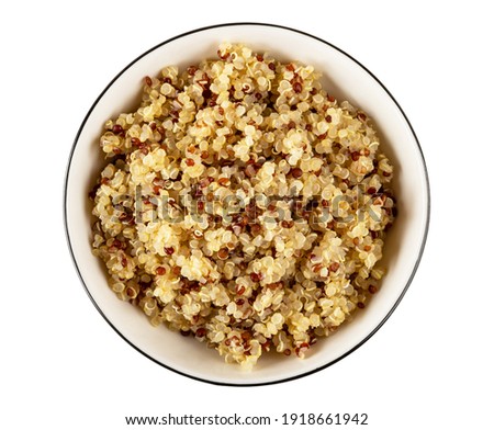 Boiled quinoa in white glass bowl isolated on white background. Top view