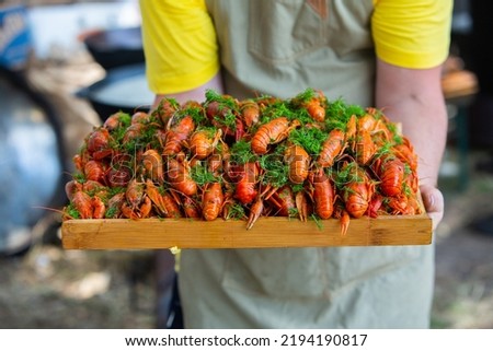 Boiled red crayfish or crawfish with herbs. Crayfish boiling in the pot on the fire.