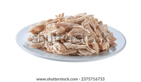 Boiled shredded chicken meat in a ceramic plate isolated on a white background.