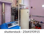 Boiler room. Heating equipment inside basement. Gas boiler for heating water. Heating equipment for winter region. Boiler room with motor for water recirculation. Tanks for warming water