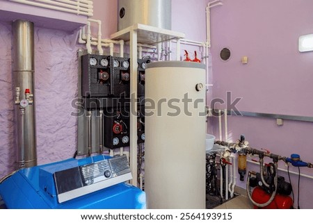 Boiler room. Heating equipment inside basement. Gas boiler for heating water. Heating equipment for winter region. Boiler room with motor for water recirculation. Tanks for warming water