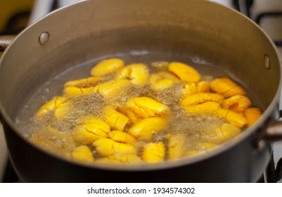 Boiling ackee fruit, considered a dietary food in Jamaica and the Caribbean.