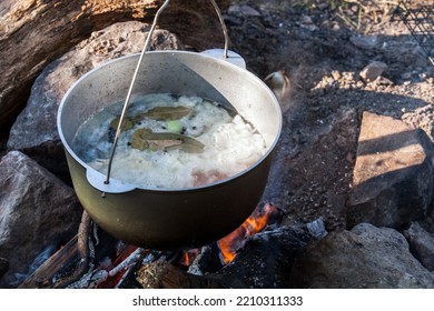 Boiling Cauldron Hangs Over An Open Fire, Camping Meal