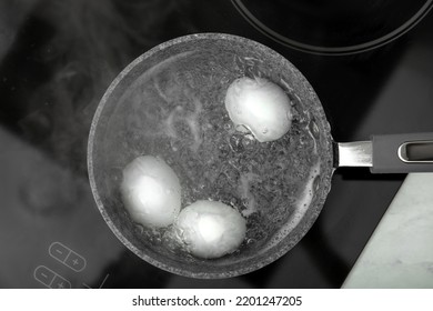 Boiling Chicken Eggs In Saucepan On Electric Stove, Top View