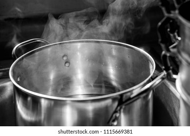 Boiling Hot Water With The Steam In The Pot