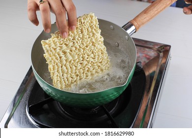 Boiling Korean Instant Noodle (Spicy Ramyun) on Sauce Pan, Add Noodle to the Pan, Home Cooking Activity - Shutterstock ID 1816629980