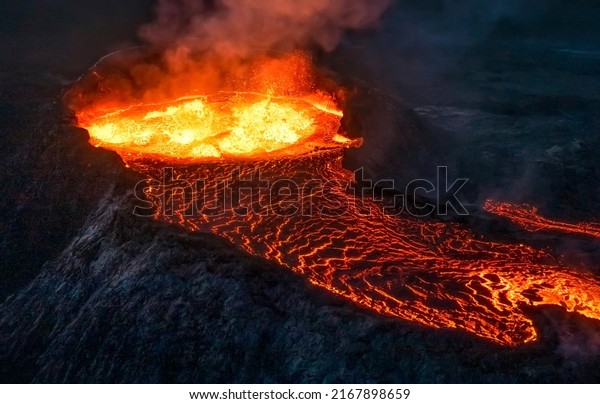 Boiling lava erupts from a\
volcano. Eruption of volcano. Volcanic eruption magma. Erupting\
volcano lava