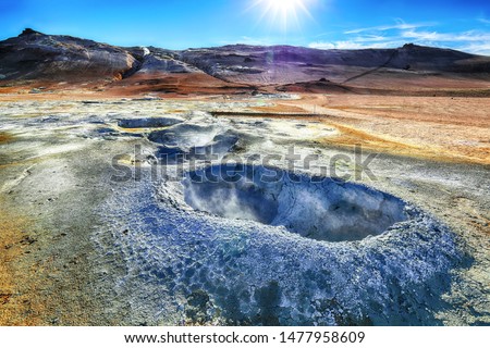 Boiling mudpots in the geothermal area Hverir and cracked ground around.  Location: geothermal area Hverir, Myvatn region, North part of Iceland, Europe