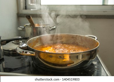 Boiling pot of Chraime, a traditional sephardic north African soup, with fish and vegetables, being cooked next to the window