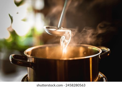 A boiling pot steams up as a resturant's chef uses a ladle to stir soup in a cooking pot in the morning. - Powered by Shutterstock