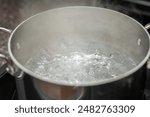 Boiling pot of water, metal pot with water ready for pasta