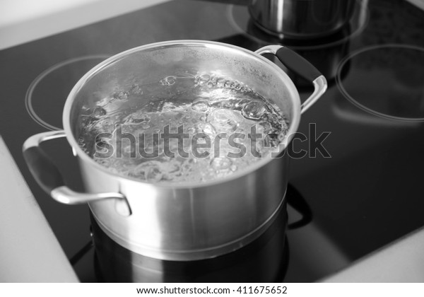 Boiling\
spaghetti in pan on electric stove in the\
kitchen