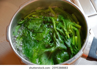 Boiling spinach in the kitchen