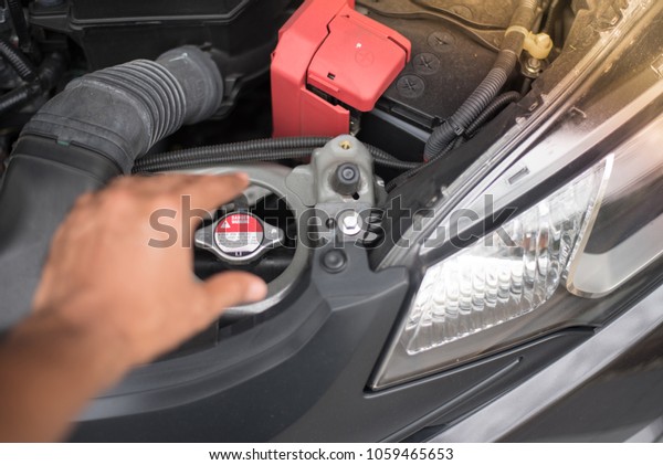 Boiling water in engine car. Don\'t touch a cap of\
radiater of engine