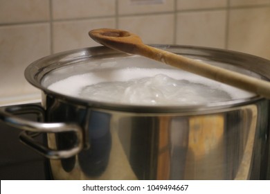 Boiling Water In A Pan, Wood Spoon On The Top 