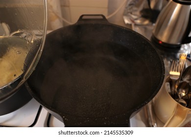Boiling water in a pot over the fire and steam rising