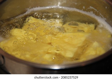 Boiling water in a saucepan with potatoes. Backgrounds