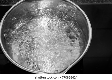 Boiling Water In Silver Pan In Kitchen 