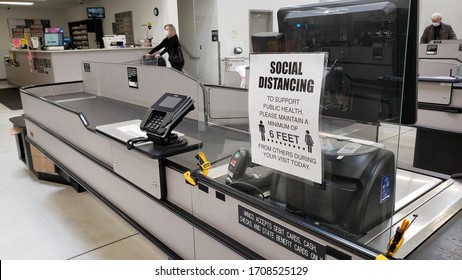 Boise, Idaho April 16, 2020 - Empty checkout line in grocery store with social distancing sign during COVID-19 Coronavirus crisis. 