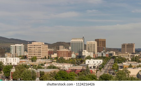 Boise, Idaho. Cityscape with a view from the west. Downtown streets and skyscrapers and the Boise Foothills on a summer evening.