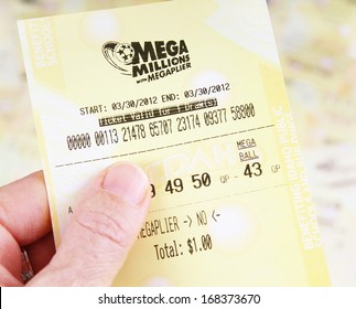 BOISE, IDAHO - DECEMBER 21, 2013: A Woman's Hand Holding A Mega Millions Lottery Ticket On December 21, 2013 In Bosie, Idaho.