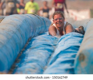 BOISE, IDAHO/USA - AUGUST 10: Unidentified woman slides face first down the slide at the The Dirty Dash in Boise, Idaho on August 10, 2013 