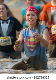 BOISE, IDAHO/USA - AUGUST 10: Woman Dances Near The Finish Line In The Mud At The The Dirty Dash In Boise, Idaho On August 10, 2013 