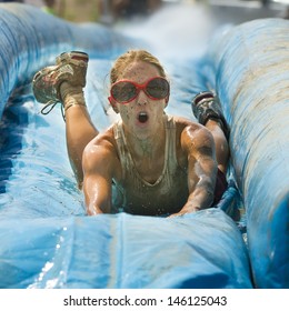 BOISE/IDAHO - AUGUST 25: Head on view of a runner taking on the slide during The Dirty Dash in Boise, Idaho on August 25, 2012