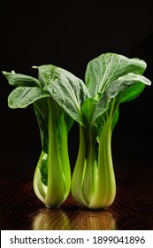 Bok Choy Fresh Standing On Table, Black Background